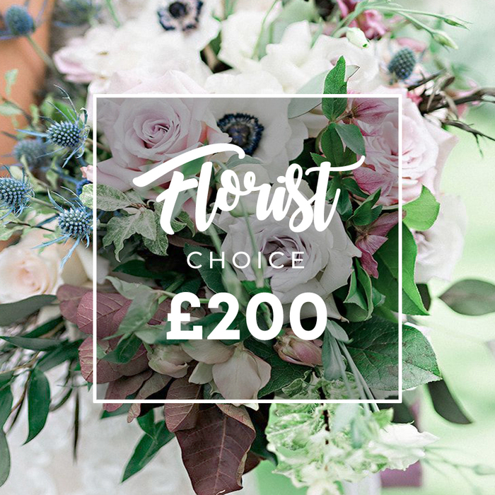 This high-end Florist Choice bouquet, priced at ?200, is a couture expression of North Watford craftsmanship. The image emphasizes a soft pastel core punctuated by white and pale rose tones, anchored by fully open light pink garden roses and creamy white to lavender-grey roses, with crisp white anemones that expose their dramatic dark centres. A sculptural fringe of blue eryngium thistles introduces a crisp, architectural note, while lush greenery-eucalyptus-like leaves and burgundy-toned foliage-that gives depth and a natural, gallery-ready finish. The semi-transparent white rectangle at the center bears Florist CHOICE and the bold ?200, a clear, elegant label that underscores the bouquet's curated, premium nature. The background is deliberately blurred, suggesting an outdoor, sunlit setting that frames the arrangement as a statement piece for weddings, anniversaries, or sophisticated home décor. The bouquet's balance reads as substantial and designer, with stems arranged to allow each element to breathe while maintaining a cohesive, luxurious silhouette. It's the kind of product a Flower Delivery North Watford showroom near Watford Junction would present, ready for same-day delivery to nearby streets such as Meriden or Callowland, or for delivery to larger events across the area. The overall impression is one of refined luxury, longevity, and careful selection, reflecting a commitment to freshness, quality, and thoughtful gifting that Flower Delivery North Watford stands for. It is a bouquet designed to be photographed, admired, and remembered long after the event.