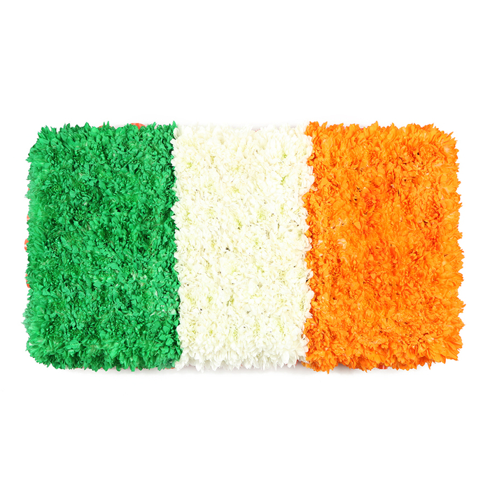 An elegant rectangular floral rendition captures the cadence of a national flag through petals. Three equal vertical bands-the left emerald green, the center white, and the right bright orange-are formed from thousands of tiny blossoms chosen for vibrancy and uniformity. The green stripe resembles a moss-soft carpet of blooms; the white band glows with a cloud-like density; the orange stripe radiates warmth with the same intricate texture.

Set against a crisp white field, the composition feels balanced, sophisticated, and celebratory, yet deeply respectful. The surface invites the eye to follow the lines, to appreciate the tender artistry of each petal, and to sense the maker's crafted intent. This portrayal of Ireland's tricolour works beautifully as a centerpiece for St Patrick's Day remembrances, community gatherings, or cultural features in North Watford and nearby areas such as Cassiobury Park and the High Street.

Delivered locally to homes and venues across North Watford, the piece blends heritage with contemporary floristry, offering a dignified charm for any occasion and a reminder that colour and craft can carry memory as surely as any spoken tribute.