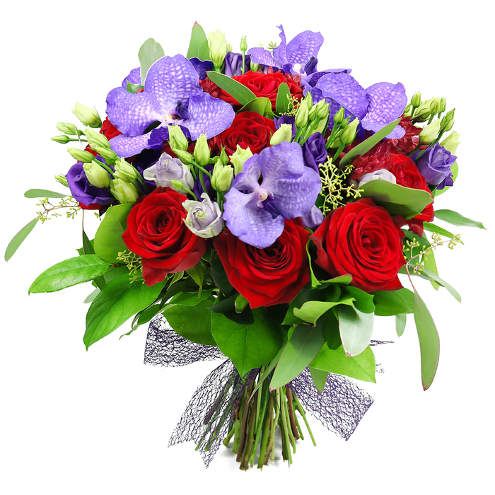 An opulent yet balanced bouquet dominates the frame, its deep reds and resonant purples harmonizing like a sunset over North Watford's leafy streets. The arrangement is artfully rounded, each stem chosen for warmth of color and textural contrast, with velvety red roses standing as anchors while purple Vanda orchids lend an aristocratic polish with their broad, speckled petals. Sprays of lisianthus in lilac and ivory weave through, their soft curves echoing a quiet breath between more assertive blooms. The verdant backbone-glossy green leaves of varying shapes, interspersed with unopened buds and slender filler stems-provides a lush, natural frame that makes the entire composition feel abundant yet refined. At the base, the stems are tied with a dark mesh ribbon in a near-black or deep plum hue, its geometric weave adding modern sophistication to a timeless bouquet. Light in tone and regal in presence, it is a piece that suits anniversaries, celebrations, and expressions of deep admiration. In a North Watford setting, imagine this arrangement gracing a dining room on a Saturday evening, catching morning light through a window near Cassiobury Park, or welcoming guests at the door of a family home on a special day. Delivered fresh from a trusted local florist, it carries not only colour but a quiet narrative of romance and craftsmanship that speaks to refined taste and heartfelt intention.