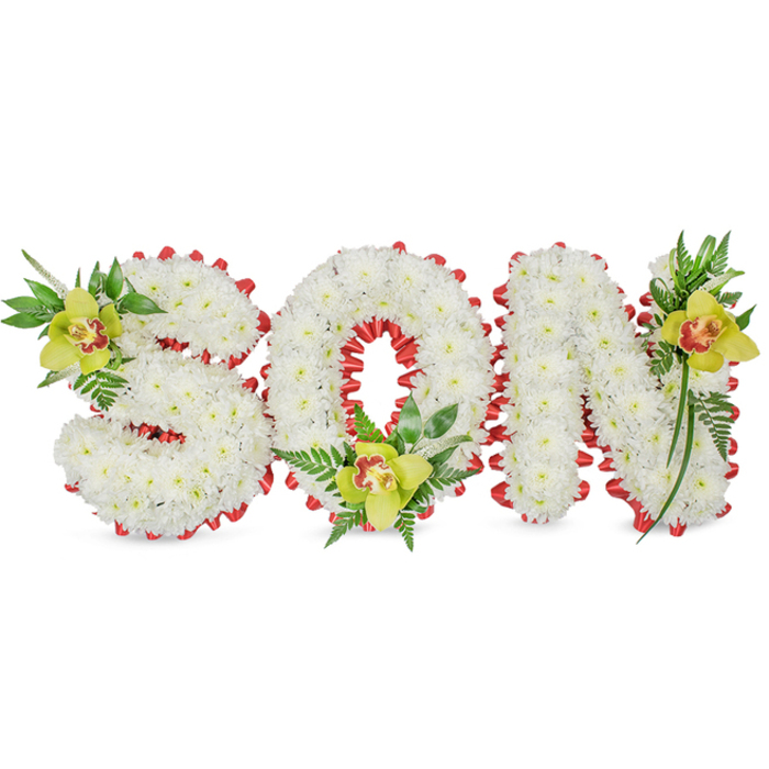 A carefully composed memorial arrangement spells the word 'SON' in bold, three-dimensional letters formed from compact clusters of pristine white chrysanthemums, their tiny petals packed to create a uniform, cloud-like mass. Each letter's edge is traced with a neat, scalloped red ribbon that peeks out from beneath the chrysanthemums, offering a vivid boundary and a visual cadence that guides the eye across the composition. The hollow of the 'O' is employed as a central focal point, while the upper curve of the 'S' and the high stroke of the 'N' are balanced by botanical accents. Placed deliberately at these points are three yellow-green Cymbidium orchids with waxy petals and a striking reddish-brown marking in the throat - one at the upper left of the 'S', one at the base of the 'O', and one at the upper right of the 'N' - each cradled by a spray of glossy foliage and fine fern fronds that trail and lift, creating gentle movement and vertical interest. The tactile contrast between the chrysanthemum's delicate, papery petals and the orchids' smooth, resilient blooms gives the arrangement depth, while a soft, neutral background and even daylight illumination allow every texture to read clearly. This is the sort of refined, personalised tribute families request for funerals, memorial services, or cemetery displays, a composition that speaks of purity, remembrance and careful craftsmanship - the same approach we use when delivering sympathy tributes to addresses across North Watford and nearby streets such as Beechen Grove and Woodstock Road.