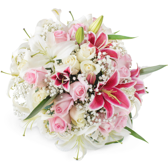 Set against a crisp white background, this abundant, hand-tied bouquet forms a perfectly rounded dome of lilies, roses, and baby's breath, much like one you might see arranged by a seasoned North Watford florist for a special family occasion. Dominating the upper layer are broad, immaculate white lilies, their trumpet-shaped petals unfolding with a gentle curve and revealing pale green or slightly yellowed stamens at the centre. Intertwined throughout the design are clusters of tender pink roses in a soft blush tone and creamy ivory roses, with buds at various stages of opening so that tight, cupped forms sit alongside full, luxuriously layered blooms. Punctuating the softer pastels, several bold Oriental lilies in vivid shades of fuchsia and magenta, similar to classic Stargazer lilies, introduce dramatic contrast; their petals are marked by delicate speckles and warmed by golden-yellow anthers that catch the light. Surrounding and binding all these focal flowers is a fine haze of white baby's breath, each tiny blossom adding a light, cloudlike texture that softens the bouquet's edges. Here and there, narrow green lily leaves and subtle stems emerge from beneath the blossoms, creating a natural green framework without distracting from the romantic colour scheme. The bright, even lighting emphasizes the freshness of each petal and the intricate construction of the bouquet. This composition suggests refined celebration and heartfelt affection, suited to a wedding near North Watford's churches, an anniversary dinner at home, or a thoughtful delivery to friends living off St Albans Road, wherever a message of love, admiration, or gentle remembrance is needed.