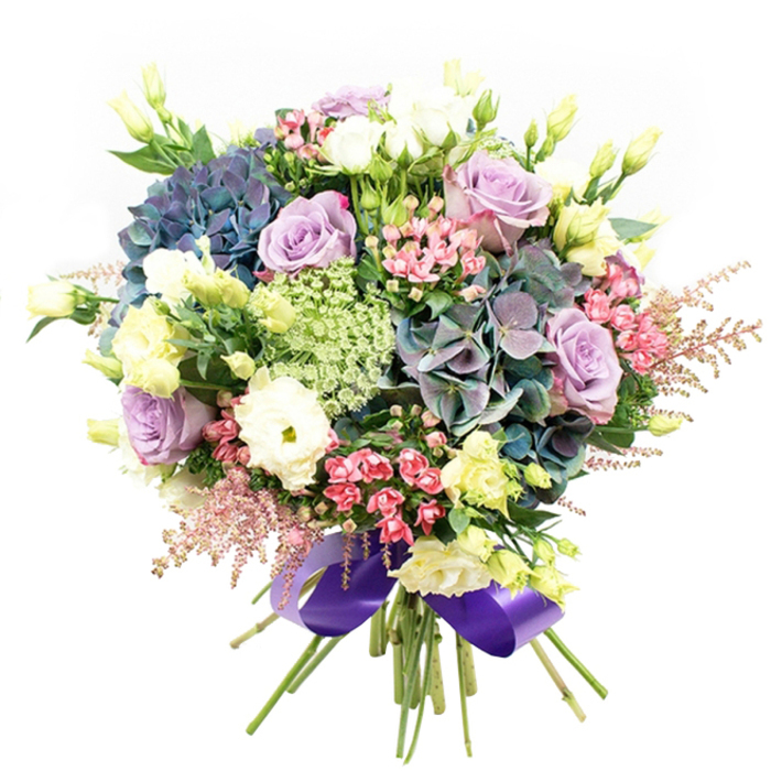 Radiant and sophisticated, this North Watford bouquet is a showcase of expert floristry, thoughtfully composed for those special moments and heartfelt gestures. The design centres on showstopping hydrangeas in layered shades of deep indigo, teal, and muted purple, their plush forms providing rich texture and depth reminiscent of lush summer plantings along St Albans Road. Scattered among these anchors bloom roses in delicate lavender and pristine cream, their petals elegantly unfurling for enhanced visual interest and an understated sense of grace. Snowy ranunculus blossoms bring that coveted multi-petaled richness, softening the composition and providing gentle contrast. Threaded throughout the bouquet, slender stems of pale yellow eustoma and partially opened lisianthus buds lift the arrangement, creating a sense of movement and airy openness reminiscent of freshly cut Watford garden stems. Sprays of vivid fuchsia and feathery pink astilbe introduce bursts of colour and a whimsical touch, harmoniously framed by finely textured light green Ammi Majus and soft, verdant foliage. The overall effect is one of abundance and natural artistry, every bloom purposefully placed for balanced energy and elegance. A wide, glossy royal purple satin ribbon encircles the gathered stems, echoing the bouquet's cool-toned palette and adding a finishing note of luxury. Available for delivery throughout North Watford, this bouquet is the perfect centrepiece for your celebrations, effortlessly blending modern sensibility with classic floral tradition.