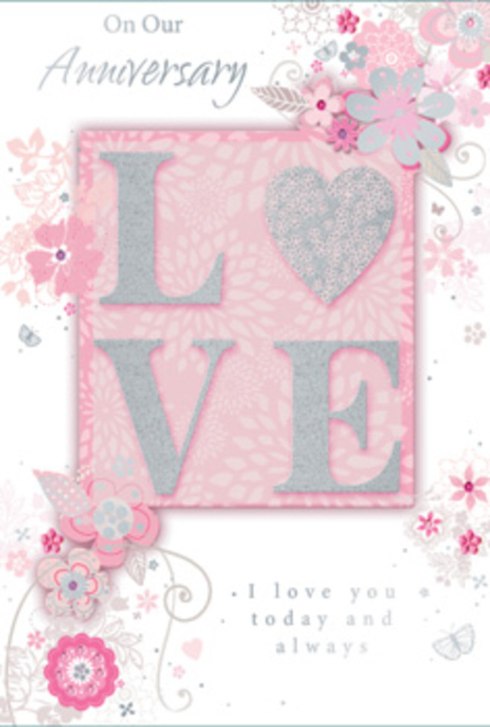 The anniversary card in this image exudes a soft, timeless romance, with its colour story woven from blush pink, pearl white, and subtle silver, much like a tasteful arrangement a North Watford florist might craft for a long-married couple. At the heart of the design, the word LOVE is prominently featured in raised, glitter-touched letters. The glitter is fine and frosted rather than chunky, catching the light in a way that suggests delicacy and care. You can almost imagine the sensation of running a fingertip over each letter, feeling the contrast between the smooth card and the slightly rough sparkle. Surrounding this central word, wisps of hand-drawn flowers and slender leaves curl and drift outward, framing the message without crowding it. The blooms are outlined in fine lines, then shaded with soft washes of blush, ivory, and pale grey, giving them a romantic, sketchbook quality that recalls a florist's first ideas for a hand-tied anniversary bouquet. The background is a gentle pink, evenly toned and serene, reminiscent of early evening light falling over front gardens near North Watford's residential lanes. Throughout the card, the floral scrolls and subtle flourishes create the sensation of movement, as if a light breeze were passing through an arrangement on a dining table. An elegant, flowing script delivers a heartfelt anniversary sentiment, its curves echoing the shapes of petals and vines. The overall impression is one of quiet gratitude and enduring tenderness, making this card feel like a paper companion to a lovingly prepared bouquet, perfect for celebrating years of shared life in North Watford.