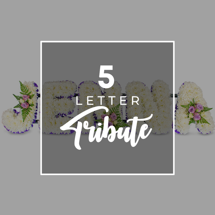 This photograph shows a lovingly crafted five-letter floral funeral tribute, the sort of bespoke design often chosen by families in North Watford to spell out a first name or affectionate word of farewell. Set against a clean, light grey background, the letters lie horizontally, each one solid and clearly shaped beneath a dense blanket of snowy white chrysanthemums or carnations. The flowers are placed petal to petal, forming a velvety, cushion-like surface that softens every angle and curve, echoing the gentle, contemplative mood of a memorial service. Around the edge of every letter runs a slim trim of deep purple satin ribbon, its smooth, lustrous finish catching the light and giving a refined outline that separates the white blooms from the neutral backdrop. Here and there, clusters of pale pink and lilac-toned spray roses rest among sprigs of glossy foliage and light, feathery ferns, bringing in subtle colour and movement, not unlike small pockets of blossom you might notice along quiet roads near the park in North Watford. In the centre of the image, a slightly darker grey square, framed with a white border, overlays part of the tribute and carries the wording 5 LETTER in a modern white font, with Tribute written below in a graceful script, clearly identifying the design as a customisable five-letter arrangement. Though the names J, O, H, N, and A are partially hidden, their forms still emerge from behind the overlay, emphasising the possibility of tailoring each letter to a specific name. The mood is one of respectful remembrance and understated beauty, capturing how fresh flowers can express tenderness, love, and dignity during a final goodbye in the local community.