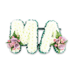 A personalised funeral flower tribute in the form of the letters MA is shown in clear detail against a simple white background, the sort of image you might see when choosing sympathy flowers for a North Watford service. Both capital letters are constructed from dense, immaculate white chrysanthemums, each bloom carefully positioned so that the petals overlap and create a smooth, plush surface. The chrysanthemums give the letters a soft, almost velvety texture, like freshly fallen snow, while their pure white colour suggests peace, remembrance, and the quiet love often associated with a devoted mum or mama. Around the outline of each letter runs a rich dark green edging, most likely folded satin ribbon or ruffled foliage, which crisply defines the M and A and adds a refined contrast against the mass of white petals. Linking the two shapes is a discreet horizontal support bar in dark green, helping them stand together as one united tribute. At the base of the left leg of the M and the right leg of the A, complementary clusters of pastel flowers soften the design. These sprays feature lilac and pale pink roses, along with smaller pink spray roses nestled closely together, their layered petals opening in gentle spirals. Light, airy fern fronds and touches of greenery weave between the blooms, adding texture and a natural flourish reminiscent of the greenery you might spot around North Watford's tree-lined residential streets. The arrangement feels dignified yet tender, suitable for resting atop a coffin, beside a framed photograph, or on a memorial table at a local North Watford chapel. It conveys a message of enduring love, gratitude, and calm farewell through thoughtful flower choice and expert craftsmanship.