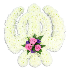 A striking Khanda-shaped funeral tribute fills the frame, the revered Sikh symbol recreated with meticulous care from a mass of snow-white chrysanthemum blooms. Each tiny flowerhead is nestled closely to the next, forming a continuous, cushion-like surface that cleanly outlines the central double-edged sword, the perfect circle of the chakkar, and the graceful sweep of the two crossed kirpans at the sides. The white petals create a soft halo of purity, while faint shadows between the blooms add quiet depth and texture. At the very base of the emblem, framed by the tips of the kirpans, sits a thoughtful cluster of accent flowers: three dusky pink roses, almost jewel-like against the white, accompanied by smaller deep purple blossoms and feathery green ferns. Their colours feel gentle rather than bright, conveying tenderness and private grief. The tribute is photographed against a plain, luminous white background, with subtle studio lighting that highlights every curve and edge of the design, allowing the floral Khanda to almost appear as if it is floating. This arrangement would be chosen by Sikh families in North Watford who wish to honour a loved one's faith and life with a bespoke floral symbol at a funeral, cremation, or memorial service. It feels appropriate for a quiet farewell at a local gurdwara or funeral home, where the carefully arranged flowers can speak of devotion, respect, and shared community roots around St Albans Road, Holywell, and the surrounding North Watford neighbourhoods.