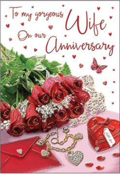 This anniversary card design unfolds like a quiet love story told in objects, styled with the eye of a local North Watford florist. A small yet lush gathering of deep red roses dominates the foreground, each blossom unfurling in layers of velvety petals that suggest both passion and comfort. Their rich colour is framed by lively green leaves, which arch gracefully and lend a fresh, garden-picked feel, as if they had just been arranged in a shop off St Albans Road. To one side rests a neatly placed envelope, slightly open as though revealing a heartfelt message only the couple will ever read. Nearby, a ruby-coloured heart box and a delicate piece of jewellery-perhaps a pendant or bracelet-lie carefully positioned, their polished surfaces reflecting the soft light that washes over the scene. Scattered around are tiny heart motifs and light-catching accents that echo the glimmer of candlelight at an anniversary dinner. A single butterfly hovers in the design, its fragile wings adding a note of transformation and shared journeys. The warm, even lighting and gentle shadows create a sense of intimacy, as if this still life had been composed on a bedside table after a surprise delivery. Together, the roses, keepsakes, and hand-written card evoke the quiet joy of anniversaries celebrated in North Watford homes, honouring memories of first dates, shared walks towards Garston, and the reassuring promise of many more years ahead.