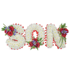 Arranged with quiet care and floral expertise by a North Watford workshop, this memorial piece spells SON in bold, three-dimensional capitals made entirely from tiny, pristine white chrysanthemums. The tightly packed blooms form a soft, cloud-like texture across each letter, while a vivid red satin ribbon outlines every edge in a scalloped trim, providing striking contrast and a formal, finished profile. Thoughtful accent groupings punctuate the lettering: the S is accented at its upper-left curve with several deep red roses, slim blue-purple spike flowers (resembling Liatris) and lush ferny greens; the O is adorned low at its bottom centre with a matching spray; and the N receives a composed cluster along its upper-right vertical, where trailing leaves lend a gentle cascade. The reds read as a statement of enduring love, the white as purity and peace; together the palette is both traditional and deeply personal. The flowers have a muted, comforting scent-roses warm and familiar, chrysanthemums clean and soft-accented by the fresh green aroma of the foliage. Set against a pristine white background and photographed in soft, natural light, the tribute conveys dignity and intimacy suitable for funeral services, wakes or graveside displays. Flower Delivery North Watford prepares similar bespoke lettering for local services around Vicarage Road, Watford High Street and community chapels, ensuring each piece is balanced, secure and ready to convey sympathy with quiet grace.