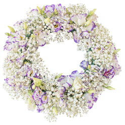 A round floral wreath is shown in full focus against a bright, uncluttered white background, highlighting the precision of its perfectly even circle and the lush texture of every bloom. The wreath is densely woven with countless stems of white Baby's Breath, their tiny flowers creating a fluffy, cloud-like surface that feels light yet beautifully full. Scattered throughout this soft white halo are striking Lisianthus flowers, their petals delicately ruffled and layered. Each Lisianthus is predominantly white, but the petal edges are traced with gentle shades of purple and violet, some with deeper, more dramatic outlines, others fading softly into lilac. A few buds remain partially closed, their pale green and creamy outer petals hinting at the purple and white to emerge as they open. The balance of small, airy blooms and larger, more sculptural flowers gives the wreath a sense of movement and life, as though a gentle breeze might pass through it. The open centre of the wreath is clearly defined, reinforcing the classic ring shape associated with eternity, remembrance, and the cycle of life. The mood of the arrangement is calm and contemplative, ideally suited to a sympathy tribute or funeral service in North Watford, perhaps making its way to a family gathering near Garston or around the quiet residential streets off St Albans Road. The neutral background in the image ensures that every petal and sprig stands out, allowing you to sense the careful craftsmanship behind the design. It is a wreath that conveys love, respect, and a peaceful farewell without the need for spoken words.