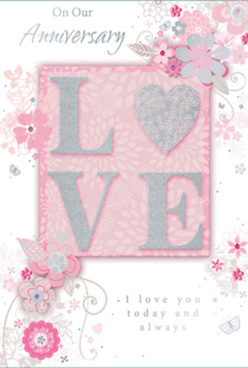 This image shows a romantic anniversary card designed in a gentle palette of pearly white, powder pink, and misty grey, the sort of soft, refined colours you might see in a carefully composed bouquet delivered across North Watford. At the centre of the card, the word "LOVE" appears in raised lettering, generously dusted with ultra-fine glitter that glimmers when it catches the light, giving a tactile, almost velvety finish. Each letter is bold yet graceful, sitting atop a blush background that appears to glow from within, like evening light filtering through a sheer curtain. Flowing out from behind the word, a cascade of illustrated flowers, leaves, and curling vines drifts diagonally across the card. The blossoms are stylised rather than botanically precise, but you can sense hints of roses and garden blooms, their petals shaded in pinks and soft creams, with silver accents that subtly outline the shapes. These floral scrolls resemble the initial pencil sketches a florist might draw when planning a romantic anniversary arrangement for a couple living near Garston or along St Albans Road. The background remains mostly uncluttered, creating a sense of space and calm, so each flourished line and petal feels intentional. A delicate scripted message sits harmoniously within the design, expressing heartfelt anniversary wishes without overwhelming the artwork. Overall, the card carries a quiet, intimate beauty, as if it has been thoughtfully chosen to accompany a bouquet delivered to a doorstep in North Watford-a graceful keepsake that celebrates enduring affection and shared history.