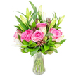 A fresh, hand-arranged bouquet of deep pink roses and white lily buds sits in a clear glass vase, photographed against a clean white background. Several large roses form the heart of the composition, their velvety petals unfurling in layered shades of fuchsia and soft blush; each petal catches the light with a satin sheen that suggests a gentle, romantic perfume. Interspersed among the roses are tall white lily buds - some tightly closed with pale green tips, others just beginning to reveal trumpet-shaped ivory petals and the faint, powdery scent that lilies bring. Lush green foliage wraps around and supports every bloom: broad glossy leaves, pointed mid-green stems, and finer sprigs that add texture and airiness. Small, darker burgundy or reddish-brown accents and tiny filler buds punctuate the arrangement, giving depth and a subtle counterpoint to the pink-and-white palette. The vase is simple and transparent with a slightly tapered base; clear water shows the neatly trimmed green stems and the crisp cut ends, conveying the bouquet's freshness. Soft, neutral studio lighting highlights petal contours and the contrast between the blooms and foliage, producing a calm, celebratory mood ideal for birthdays, anniversaries, or a thoughtful thank-you. As a local florist would describe it to someone who cannot see, the bouquet feels full, balanced, and intentionally composed - a timeless gift to brighten a North Watford sitting room or to sit centre-stage as a cheerful table centerpiece near Cassiobury Park or on Watford High Street.