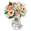 Vivid and heartfelt, this mixed flower bouquet is stylishly set against a gleaming white background-a perfect showcase of North Watford's sense of community and natural beauty. At center stage, broad peach-pink roses bloom with gentle elegance, their full petals inviting the eye and suggesting a comforting embrace. Two radiant gerbera daisies, shining in sunset shades of peach and orange, are perfectly positioned to add bold structure, their iconic brown centers drawing focus. Around them, soft mounds of baby's breath blossom, creating an atmosphere of softness and tranquility and connecting one bloom to the next like newfound friendships along Leavesden Road. Fresh white chrysanthemums-each highlighted with a joyful green center-intermingle with lush greenery that lends texture, fragrance, and a subtle nod to the gardens of Watford. The clear glass vase, modestly textured, captures the moment with an honest simplicity: stems are carefully arranged, standing tall in sparkling water that sings of freshness. A rustic string bow, tied at the rim, suspends a clean white tag at its front-hinting at an upcoming celebration or a bridge across miles to someone dear in North Watford. Every visual and tactile detail has been selected to communicate warmth, gratitude, and everyday joy, reflecting a bouquet made truly local by thoughtful hands.