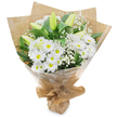 A quietly elegant hand-tied bouquet captured against a bright white background, where white and green tones sing with calm confidence. At the very top and center, several white lilies lift their broad, gently curving petals - some fully open to reveal pale stamens, others held tight as green-tinged buds - so the composition reads as a moment in time, part-bloomed and part-promise. Clustered below and around the lilies are generous heads of white, daisy-like chrysanthemums; each chrysanthemum is built from many fine, overlapping petals radiating from a soft yellow-green eye, giving the bouquet a generous, textural fullness. Wisps of airy baby's breath (Gypsophila) float between the larger blooms like pale mist, softening edges and adding a delicate, cloud-like surface that invites touch. Deep, glossy green foliage and long stems provide a living frame, their rich tones setting the whites in crisp relief and lending the arrangement depth and structure. The florist's hand is visible in the finish: an inner wrap of crinkled brown kraft paper gives an earthy, tactile base, while an outer layer of clear cellophane lends a subtle sheen and protects the flowers; the wrapping is neatly gathered and tied at the stems, forming a convenient stand for presentation. In soft morning light the bouquet reads as pure and restorative - the scent faintly green and clean, with a hint of fresh cut stems and the softer perfume of lilies. A versatile arrangement, it expresses sympathy or solace as readily as gentle congratulations, and it carries the attentive craftsmanship of a local florist familiar with North Watford's quieter moments and everyday kindnesses.