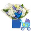 A radiant, celebratory bouquet captured against a clean white backdrop: a round, generous cluster of fresh blooms set in a matte royal-blue presentation box, its deep colour anchoring the cool palette. At the heart are creamy white roses and full, fluffy chrysanthemums whose layered petals give a soft, pillow-like texture; among them, white lilies reach gently upward, some still closed in pale green-tinted buds that speak of new beginnings. Bright electric-blue chrysanthemums and a few intensely hued blue carnations or delphinium-like stems punctuate the arrangement, offering a joyful, modern pop of colour. Interspersed clusters of soft lavender hyacinth-style flowers lend a delicate, bell-shaped texture and a faint floral perfume that mingles with the green, slightly peppery scent of fresh foliage. Broad glossy leaves and feathery fern fronds create depth, framing the blooms and catching the light so the whites appear luminous against the navy box. The whole bouquet is gathered in crinkled cream tissue that adds a tactile, handcrafted finish.To the right of the flowers a light-blue foil balloon shaped like an old-fashioned baby carriage completes the scene. The carriage shows darker blue canopy and wheel accents with tiny hearts and polka dots, and the playful lettering announces the happy news with It's a Boy in bright yellow-green tones. The composition feels like a warm welcome for a newborn son-perfect for a hospital visit or homecoming near Cassiobury Park or Watford High Street-and radiates thoughtful care, freshness, and the quiet joy of a new family beginning close to home in North Watford.