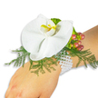 A refined wrist corsage rests gently on the fair-skinned wrist of a person, photographed against a clean, bright white background so every petal and bead reads clearly. The focal bloom is a single, pristine white Phalaenopsis orchid-its broad, smooth petals unfolding like porcelain-and the small labellum at the center glows a warm yellow with touches of deeper orange, drawing the eye inward with quiet warmth. Around the orchid a soft halo of asparagus-fern foliage fans outward in featherlike green, giving the blossom a natural, airy pedestal that contrasts the orchid's satin surface. To one side, a tight cluster of Hypericum berries transitions from pale green through blush to cranberry red, their glossy skins catching the light and adding a jewel-like punctuation to the composition. Near the berries, a ruffled, lime-green accent leaf adds fresh texture and a modern edge without overpowering the delicate bloom.

The floral elements are anchored to the wrist by a multi-strand bracelet of lustrous white pearls; the tiny beads sit warm against skin, lending heirloom sophistication and a tactile, comfortable fit. The lighting is soft and even-studio-bright yet gentle-so the orchid's subtle veins, the fern's fine filigree, and the berries' satiny sheen are all visible. This corsage reads as timeless and romantic: perfectly suited to a wedding, prom, or graduation where understated luxury is desired. A viewer can almost sense the faint, fresh scent of greens and the cool smoothness of pearls; every detail speaks to careful floristry and thoughtful design, presented simply so the flower itself remains the star.