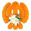 A richly textured, freestanding floral Khanda crafted from hundreds of tightly packed, bright orange marigold blossoms sits against a clean white background, the warm colour glowing as if lit by soft morning light. The arrangement faithfully reproduces the Khanda's defining elements: the central circular chakkar, two crossed kirpans arching behind it, and the upright double-edged khanda in the middle - each line and curve rendered with the tactile, velvety heads of marigolds that catch highlights and cast a gentle drop shadow beneath the piece. At the inner heart where the swords intersect, a small bouquet of pristine white lilies has been carefully placed; at least two lilies are in full bloom with petals unfurling to reveal pale green-and-yellow stamens, while several lily buds nestle close, their smooth ivory surfaces offering a calm, cool contrast to the marigolds' vivid orange. Sprays of tiny white gypsophila and glossy green foliage - pointed leaves that might be salal - fringe the central cluster, adding delicate texture and a soothing green punctuation that lifts the composition. The overall impression is one of reverent celebration: the warmth and bustle of marigolds balanced by the lilies' quiet dignity. A seasoned florist's hand is evident in the precise shaping and the three-dimensional build, a style often requested for Vaisakhi tributes and community observances around Cassiobury Park, Watford High Street and the North Watford neighbourhood. This image communicates devotion, craftsmanship, and a floral offering meant to be both visually striking and spiritually respectful.