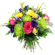 A densely packed, round hand-tied bouquet is shown against a bright white background, highlighting every vivid colour and intricate texture as if it has just been prepared in a North Watford workshop. At its heart, a cluster of bold hot pink roses opens widely, their velvety petals forming deep, spiralling cups that anchor the design with rich, romantic colour. Around them, lime green spider chrysanthemums spread out their many slender, thread-like petals, each bloom a vibrant burst of chartreuse that adds movement and a touch of whimsy. Deep indigo and violet lisianthus blooms nestle between the larger flowers; some are open and softly ruffled, while others remain in sleek, pointed buds, suggesting blossoms ready to unfold. Punctuating the arrangement, several bright yellow gerbera or daisy-style flowers glow like small suns, their round faces and numerous narrow petals evoking warmth and optimism, much like catching a shaft of light along St Albans Road on a clear day. Tucked in close, a single cream to pale yellow rosebud adds a tender, almost nostalgic note, its petals still tightly curled. Fine sprays of small lavender, lilac, and blush filler flowers weave through the composition, softening transitions between the stronger tones and creating a gentle haze of colour. Delicate green buds and stems extend upwards from the dome, lending height and a sense of fresh growth. Encircling it all is a generous layer of lush foliage: dark green, glossy leaves, airy fern fronds, and rounded, eucalyptus-like greens that provide depth and a cool contrast to the brighter blossoms. The overall impression is one of joyful abundance and thoughtful craftsmanship, an uplifting bouquet that would suit a birthday, congratulations, or simple thinking of you gesture delivered to any address in North Watford.
