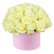 A generous dome of roses is captured in full bloom, rising gracefully from a round blush-pink hat box that suggests a sense of luxurious gifting. Each rose is meticulously placed, their heads touching in a tight, continuous cluster so that the viewer reads the arrangement as a single, billowing cushion of petals. The colours are soothing and romantic: soft cream and pale ivory dominate, with delicate hints of pastel yellow nestled at the very centre of some blooms, hinting at the first flush of opening. Petals appear smooth and velvety, their edges gently curved rather than crisp, conveying a sense of tenderness and fullness that suits an anniversary or heartfelt celebration. Near the base of the floral dome, tiny glimpses of fresh green foliage emerge, like a subtle halo that grounds the light-toned roses and hints at the natural stems below. The hat box beneath is a cylindrical pastel pink container with a matte finish, reminiscent of fine gift boxes you might spot in boutique windows along North Watford's local streets. Its simple, modern shape and soft colour perfectly complement the neutral roses above, creating a pleasing contrast that feels both contemporary and timeless. Against the pure white background, the arrangement stands alone, without ribbons, cards, or additional props, allowing the viewer to focus entirely on the craftsmanship and careful balance of colour and proportion. The image conveys a quiet yet unmistakable sense of romance and thoughtfulness, like a carefully planned anniversary flower delivery arriving at a doorstep near North Watford, ready to become the centrepiece of a cherished shared moment.