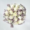 There is a tranquil elegance in this North Watford bouquet, a sense of calm that might be found on a quiet walk through Oxhey Park in the gentle light of dawn. Plush, velvety white roses, at the very peak of their freshness, form the radiant heart of this design-their petals layered in creamy spirals hinting at new stories, unspoken confidences, and promises yet to bloom. Intertwined among them are sprays of pale lavender statice, each tiny blossom lending a lace-like, airy texture that beautifully offsets the fullness of the roses. Subtle hints of foliage emerge between the blooms, grounding the arrangement and echoing the quiet greenery found throughout North Watford. Illuminated by filtered daylight, the bouquet seems to glow, the colour palette remaining pure and understated. This expertly crafted composition brings both peace and gentle celebration-ideal for offering comfort, recognising a milestone, or simply brightening a home tucked away on a serene residential street. The effect lingers like the softest floral scent, a gentle reminder of care and clarity delivered with the personal touch of a North Watford florist.