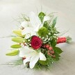 From a softly elevated perspective, this vibrant hand-tied bouquet rests on a gentle off-white background, its elegant mix of florals capturing the charm of North Watford celebrations. At the bouquet's upper arc, luscious white lilies-some blooming wide with golden stamens, others curled tightly in hopeful green buds-bring a sense of purity and fresh beginnings, much like the cheerful atmosphere near North Watford's bustling markets. A richly hued, velvety red rose draws the gaze at the arrangement's center, infusing classic passion and striking color against the whites and greens. Textural green trick dianthus and playful clusters of glossy red hypericum berries bring vivid, modern accents throughout, as do the delicate airy sprigs of white gypsophila, which seem almost cloud-like in their lightness. Surrounding the blooms, a tapestry of deep green foliage-from broad, polished leaves to fine, feathery tendrils-creates fullness and showcases the florist's attentive hand. The bouquet's stems are gathered and wrapped with a bright, luxurious red satin ribbon, echoing the joyful energy of special events from Watford Fields to North Watford's high streets. This arrangement embodies love, freshness, and thoughtful design, making it an ideal choice for local weddings, anniversaries, or heartfelt gifts, and reflecting the genuine care North Watford florists weave into every creation.