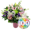 This image shows a jubilant centenary-themed floral and balloon display, captured against a spotless white background that makes every colour stand out clearly. On the left, a ribbed, matte pink vase holds a lavish bouquet, overflowing with pastel blooms and lush greenery that feel at once elegant and joyful. At the heart of the arrangement, several pale pink Oriental lilies rise above the other stems; some flowers are fully open, revealing their long stamens and gently curved petals, while others remain in smooth, unopened buds. Nestled around them, layers of soft pink and dusty rose-toned roses are arranged tightly, their velvety petals suggesting romance and affection built up over many years. Pockets of deep purple lisianthus and small lavender asters with bright yellow centres add contrast and visual rhythm, while rounded lime green button chrysanthemums provide lively pops of fresh, modern colour. Delicate sprays of white baby's breath drift through the bouquet like fine mist, softening the edges and giving the whole design a light, airy feel. Dark green foliage in different shapes and textures underpins the composition, hinting at the careful craftsmanship of a local North Watford florist accustomed to designing for important family milestones. To the lower right, a glossy round foil balloon leans toward the bouquet. Its surface is covered with vibrant confetti dots in red, orange, yellow, green, blue, and purple, cradling the large white numerals 100, which stand out with a subtle shadowed effect. The combination of sophisticated flowers and playful balloon perfectly captures the joy, gratitude, and significance of reaching a 100th birthday or centenary anniversary in the North Watford community, whether celebrated at home, in a care residence, or at a local hall.