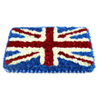 In this image, a large rectangular floral tribute is expertly arranged to replicate the Union Jack with remarkable clarity and care. The flag's deep blue field is formed from a mass of tightly packed chrysanthemum heads, creating a plush, even surface that draws the eye into its velvety depth. Over this rich blue, bold white stripes mark out St George's Cross, their lines broad and unbroken, giving the composition structure and calm authority. Diagonal streaks of intense red flowers, likely carnations chosen for their saturated hue and reliable shape, form St Patrick's Cross, each red band neatly edged with fine outlines of white blooms to keep the pattern visually distinct. The tribute is slightly domed, rising gently at the centre so that light brushes across the petals, catching small highlights and shadows that bring a subtle sense of movement. Along the bottom edge, a neatly pleated blue ribbon runs the full width of the arrangement, its satin-like sheen echoing the floral blues above and finishing the piece with a polished, ceremonial touch. Though the background is stark white, the arrangement itself suggests a setting of quiet respect, perhaps resting atop a coffin or positioned near the front of a chapel during a funeral service. It feels especially suited to North Watford families wanting to honour a loved one who valued their British heritage or served in the forces, a floral flag that might travel from a local florist near North Watford's residential streets straight to a church or crematorium. In that moment, the tribute becomes a powerful yet gentle symbol of unity, gratitude, and lasting remembrance.