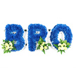 A studio portrait on a pure white background shows a three-dimensional, three-piece sympathy tribute that spells out the word BRO in bold capital letters. Each letter - B, R and O - is entirely covered in tightly packed royal blue chrysanthemum florets, producing a plush, velvety texture and a deep, even wash of colour across each form. The blue is dense and saturated, catching the soft studio light to reveal subtle petal contours and shadowed depth between blooms. At the base of each letter a small, thoughtful accent cluster settles into the curve or perimeter: pale ivory to creamy yellow roses, some in tight bud and others gently unfurling, mingled with tiny white filler blooms that could be baby's breath or mini chrysanthemums. Lush green foliage - broader glossy leaves reminiscent of salal or lemon leaf and feathery, fern-like fronds - frames these accents, adding contrast and an herbaceous, almost dewy scent suggestion. A thin white foam or base outlines the letters and is visible in the negative spaces of the B and R and the centre of the O, indicating professional foam construction and careful floral wiring. The composition is reverent and restrained, the colours chosen to suggest peace, sincerity and remembrance; the pale roses lend a soft light against the vivid blue, conveying solace and familial love. As an experienced florist in North Watford, I picture this piece placed by a chapel lectern or beside a graveside near Cassiobury Park, a personalised memorial that reads both as a name and as a quiet act of honour for a much-loved brother or close friend.