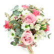 A rounded blush pink hatbox overflowing with flowers is shown against a clean, bright white backdrop, the camera angled from above to reveal the full, domed arrangement. The hatbox has a sleek, modern finish and is gently wrapped with a fine satin ribbon in a deeper rose-pink hue, finished with a small cream-coloured tag that hints at a thoughtful florist's signature touch in North Watford. From this base, a luxuriant mix of blooms rises, primarily in tones of soft pink, white, and fresh green. At the heart of the composition, several large light pink roses with velvety, spiral petals open generously, some fully unfurled and others just loosening, giving the bouquet a romantic and inviting focus. Between them, white daisy-like chrysanthemums with bright green centres bring a joyful brightness, their tidy petals radiating in perfect circles. Delicate white alstroemeria are scattered throughout, their narrower petals marked with fine purplish-red streaks and tiny spots, adding depth and an almost painterly detail, like brushstrokes on a canvas. The flowers are cradled in a blend of textured greenery: rounded eucalyptus leaves in a soft, silvery-green tone curve outward, providing a cool, misty backdrop, while darker, more slender green leaves weave through the arrangement, creating quiet movement. Small clusters of reddish-brown buds or berry-like details peek out from the foliage, contributing a hint of wild, garden-inspired charm reminiscent of a stroll through a well-tended North Watford garden. The overall effect is gentle yet uplifting, perfectly suited to sit on a coffee table in a North Watford flat as a birthday treat, an anniversary surprise, or a simple, heartfelt message of appreciation delivered from a local florist.