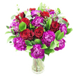A lush, rounded bouquet of deep crimson roses and magenta-purple carnations sits in a simple clear glass vase, captured in soft, even light against a clean white backdrop. The roses range from tightly furled buds to gently opened blooms whose velvety spirals invite a closer look; their deep red suggests classic romance and quiet devotion. Woven between them, densely ruffled carnations in an almost fuchsia-violet add playful texture and a contemporary pop of colour, each frill catching light at its edges like tiny waves. Bright, glossy foliage-ripe emerald ruscus or similar greens-forms a generous, verdant skeleton that lifts and frames the blooms, while slender sprigs of silvery eucalyptus breathe modern freshness through the composition and add a subtle aromatic note. The glass vase is intentionally unobtrusive, its transparency revealing clean stems and water that speak of immediate freshness and careful handling. The arrangement is full and compact, artfully balanced to present a bountiful silhouette that reads as both celebratory and refined. In my experience as a local florist, this combination works beautifully for anniversaries, romantic gestures, or to brighten a dining table in a North Watford home near Cassiobury Park; it carries warmth without fuss. The overall mood is elegant yet spirited-the deep reds steady and grounding, the purple carnations lively and imaginative-offering a tactile contrast between plush petals and crisp leaves. Viewed from any angle, the bouquet feels inviting and substantial, a thoughtful floral offering that would translate to a heartfelt delivery across the neighbourhood and beyond.