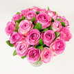 A generously rounded bouquet of roughly two dozen fresh pink roses sits in a clear glass vase, every blossom fully or nearly fully open and showing layers of velvety petals. The blooms form a dense, domed composition photographed from a slightly elevated, overhead angle that highlights the arrangement's fullness and the soft gradation of colour-from a concentrated deep fuchsia at some centres through warm rose tones to a gentle, creamy blush at the petal edges. Dark green leaves are thoughtfully tucked between the heads, their glossy texture and cool tone supplying a natural counterpoint that makes the pinks sing. The scene is lit with soft, even daylight that flattens harsh shadows and gives each petal a tender, tactile clarity; you can almost feel the silkiness under your fingertips and imagine the faint, powdery scent that lifts from the bouquet. As a florist working in North Watford, I picture this arrangement brightening a mantle on a quiet morning in Cassiobury Park or greeting guests at an intimate dinner near Watford High Street. The bouquet's mood is quietly celebratory and romantic-perfect for anniversaries, birthdays, Mother's Day, or as a thoughtful 'thank you' that says devotion without words. It reads equally well as elegant home décor or a statement centerpiece for a small gathering, its craftsmanship evident in the compact layering and careful balance of colour and foliage. The overall feeling is one of warmth and tenderness, a floral embrace that communicates joy and affection while remaining classic and refined.