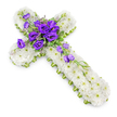 A tranquil floral cross designed for a funeral or memorial service is shown against a spotless white background, its calm presence and symbolic form immediately apparent. The entire cross shape is carefully covered with masses of white spray chrysanthemums, each blossom small yet perfectly formed, combining into a soft, continuous surface that feels gentle and comforting. These white flowers, with their tiny green centres, provide a pure canvas that speaks of innocence, peace, and spiritual rest. Around the sides, a fine lime-green ribbon frames the cross, following every curve and corner, introducing a fresh, natural border that hints at new life and hope. At the heart of the cross, where the arms intersect, sits a prominent spray of deep purple lisianthus, their velvety petals layered and full. The rich, regal tone of the purple stands in beautiful contrast to the white beneath, drawing the eye while symbolising reverence, honour, and thoughtful remembrance. Interwoven among the lisianthus are slender stems of foliage, some variegated, some in soft greens, with a few delicately placed buds that suggest ongoing life. A small cascade of lisianthus flowers and buds trails gently from the central cluster down along the lower arm, adding flow and visual movement, as though the blooms are quietly tumbling. A soft shadow below the cross lifts it slightly from the background, giving the design depth without disturbing its serenity. This is the kind of floral tribute often chosen in North Watford for church services or cemetery gatherings, offering a tender expression of condolence and faith to families saying goodbye.