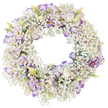 A beautifully balanced circular wreath fills the frame, displayed against a clean, white background that throws all attention onto the flowers. The base of the design is created from abundant white Baby's Breath, each tiny blossom combining to give the wreath a full, cloud-like appearance, as if it were a soft ring of mist made solid. Dotted throughout this soft texture are larger Lisianthus blooms with ruffled petals. Their colouring is refined and gentle: white petals edged and lightly veined with shades of lavender and purple-violet, some more strongly defined and others melting softly into the white. Several Lisianthus flowers open fully to reveal darker centres and a suggestion of golden stamens, while unopened and half-open buds, tinted with pale green and creamy tones, peek through the Baby's Breath and suggest freshness and new life. The interior of the wreath is an open circle, emphasizing the traditional ring that often represents eternity, unity, and unbroken affection. The mood conveyed by the image is calm, respectful, and soothing, the white and purple palette ideal for expressing sympathy, remembrance, and gentle support. This is the kind of tribute you might see delivered for a North Watford funeral or memorial, perhaps making its way through the quiet streets near Leavesden Road or heading toward a local crematorium. The bright background in the photo sharpens every outline, allowing you to almost feel the airy Baby's Breath under your fingertips and the soft, silk-like Lisianthus petals. It is a tender and dignified wreath, suited to honouring a loved one with grace and understated beauty.