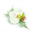 A delicate, wearable study in white and green: at the heart lies a single pristine Phalaenopsis orchid, its broad, satiny petals unfurling with a soft, waxy sheen that catches cool, studio light like polished porcelain. The orchid's throat shows a tender wash of pale yellow and gold with faint brown markings, a small sunlit secret set against immaculate white. Around it, filigree sprigs of asparagus fern fan outward with feather-light texture, lending breath and movement as if the corsage were breathing; their fine, dewy tips contrast the orchid's smooth surfaces. To the right, clusters of small, round reddish-pink hypericum berries add a warm, earthy punctuation - glossy, jewel-like, and gently rustic beside the bloom. Nestled lower and compact is a lime-green chrysanthemum or similar small mum, its tightly cupped florets offering a bright, verdant counterpoint and a hint of playful cheer. The composition sits slightly asymmetrical yet perfectly balanced, designed to be pinned to a lapel or worn on the wrist so it reads as an intimate accent rather than an ornamented statement. Photographed against a crisp white background, every subtle shadow, petal curve, and frond is clear and tactile, inviting a sense of quiet celebration. As a local florist would describe it, this corsage combines classic bridal purity with a touch of garden freshness - serene, refined, and ideal for weddings, proms, or formal occasions in and around North Watford, especially for couples who love understatement with thoughtful detail.