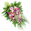 This image shows a lush, diagonal funeral spray arranged with the care and balance of an experienced local florist, resting against a clean white background so every detail is clearly defined. At the upper left, the stems are neatly gathered and secured, revealing the hand-tied craftsmanship behind the design. From that point, the spray opens into a rich fan of colour that drifts down toward the lower right, where long palm fronds trail away like a gentle farewell gesture. The central flowers are generous gerbera daisies in tones of soft powder pink and deep fuchsia, their wide petals radiating like small suns. Intertwined with them are classic pink roses, velvety and spiralled, lending romance and quiet formality. Around these, small white ruffled flowers-similar to petite carnations or dianthus-lighten the palette, while sprays of dainty white daisies with sunny centres spill through the gaps, suggesting innocence and simple joy. Here and there, bright red hypericum berries peek from the foliage, their rounded, bead-like shapes adding accent points of colour and natural texture. The whole piece is cradled in abundant greenery: glossy dark leaves provide a strong base; feathery ferns fringe the edges; and cool, silvery eucalyptus leaves offer a contemporary softness and an implied fresh, herbal scent. The lighting picks up the gentle sheen on petals and leaves, as if the spray were laid out in calm daylight before a service in one of North Watford's chapels. Designed as a casket spray or significant standing tribute, this arrangement communicates comfort, respect, and tender remembrance, a fitting floral expression for saying goodbye and celebrating a life well lived.