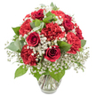 A sumptuous red and white bouquet is presented in a clear glass vase, its rounded, dome-like form carefully composed and framed by a clean, bright white background. Deep red roses, with gently spiralling petals that look almost velvety to the touch, rise proudly at the centre and throughout the design, their classic shape instantly suggesting romance and devotion. Intermingled with the roses are full-headed red carnations, their finely ruffled petals packed densely together to create a soft yet dramatic texture, each bloom varying just slightly in hue to give the arrangement a natural, lively feel. Between these passionate reds, airy sprays of white baby's breath float like tiny clouds, filling the spaces with delicate specks of white that bring balance, lightness, and a sense of serene purity. Threaded through the composition, fresh greenery in both deep and silvery greens-likely rose foliage and rounded eucalyptus-adds structure, contrast, and the impression of freshly cut garden stems arranged just moments ago in a North Watford flower studio. The vase itself is simple and transparent, with a subtly flared top and clear water cradling the carefully trimmed stems, highlighting the professional preparation behind the beauty. Under even, bright lighting, the colours appear vivid and true, with the whites remaining crisp and the reds rich and saturated. This bouquet feels ideal for marking life's special milestones in North Watford-whether it's a cosy anniversary dinner at home off St Albans Road, a romantic surprise, or a thoughtful gesture of love and support delivered to someone special across the area.