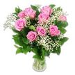 A radiant bouquet of pink roses and white baby's breath stands centred against a spotless white background, arranged in a way that feels both polished and tender, like a thoughtful baby gift delivered across North Watford. Approximately ten to twelve pink roses form a rounded, generous cluster, their petals opening in beautiful concentric layers that shift from a light, almost cotton-candy pink on the outer edges to a more saturated rosy tone toward the middle of each bloom. Some roses are fully opened and soft-looking, while others are only partly unfurled, hinting at new life and gentle growth. Interlaced with the roses are airy sprays of baby's breath, each stem covered in tiny, white blossoms that resemble little puffs of cloud. These give the arrangement a floating, dreamlike quality, especially against the bright white background. Around the flowers, dark green rose leaves add contrast and a hint of garden freshness, their surfaces appearing slightly glossy under the light. The stems are gathered into a clear glass vase with a modest shape, filled partway with water, where you can see the straight green stems overlapping in clean lines. The lighting is bright, soft, and even, similar to a clear morning in North Watford, bringing out the true colours and the velvety texture of the petals. This composition conveys calm joy and tenderness, perfectly suited for congratulating new parents near North Watford station, brightening a maternity ward room, or marking baby milestones with a simple yet heartfelt floral gesture.