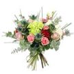 A hand-tied bouquet sits against a crisp, brilliant white backdrop, every blossom and leaf precisely visible as if held up to morning light. At its centre a voluminous cluster of lime-green hydrangea creates a soft, cloud-like focal point, the tiny petals catching light and lending a luminous, almost dewy quality. Surrounding that generous heart are classic roses in a range of romantic tones: deep, velvety red roses that speak of passion, and tender blush pink and creamy ivory roses that unfurl with gentle, romantic curves. Scattered between these are cheerful coral-pink carnations with their ruffled, frilly edges, adding warmth and a tactile, plush texture. Several metallic blue-grey Eryngium thistles punctuate the composition with architectural, spiky forms and a cool steely-blue note that contrasts beautifully with the softer blooms. The bouquet is lavishly filled with foliage: silvery-green eucalyptus leaves provide a muted, aromatic backdrop, their rounded shapes softening the arrangement, while long, upright blades of bright green grass and thin filler stems lend vertical movement and an airy silhouette. The stems are neatly gathered and bound with a natural fibre tie, revealing the fresh, green cut ends and the careful hand-tying that gives the piece its relaxed, naturalistic shape. Together the colours - chartreuse, coral, rose, cream, and blue-grey - harmonise to produce a feeling of joyful elegance. I imagine this bouquet brightening a home near Cassiobury Park or serving as a heartfelt gift for a birthday or anniversary in North Watford, offering both visual drama and a calming, garden-like scent.