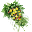 An elegant yellow rose funeral spray is pictured on a flawless white background, allowing the eye to focus entirely on the flowers and foliage. The design is long and slightly tapered, flowing from a compact, structured head at the upper left down to a lighter, more open tail at the lower right. At the core of the composition are numerous yellow roses, perhaps fifteen to twenty blooms in all, arranged in a gentle diagonal. Each rose has its own personality: some are still tightly furled, their petals wrapped close like a promise, while others have opened wider to reveal plush, velvety layers in a warm, golden yellow that feels both comforting and hopeful. Interwoven between the roses are rich clusters of small, round red berries, similar to Hypericum, their deep, glossy tones providing a beautiful counterpoint to the sunny petals. These berries lend subtle depth and texture, as if small beads of colour have been scattered with care through the arrangement. The flowers are supported by a generous foundation of greenery. At the left, broad dark green leaves are stacked and sometimes folded back, creating a lush, substantial base that conceals the bound stems beneath. As the eye travels to the right, the foliage becomes more airy, with long, palm-like fronds extending outward. These slender, feathered fronds give the spray its elegant, elongated outline and a sense of gentle movement. The piece feels ideally suited for a farewell service in North Watford, perhaps in a chapel near Garston or a cemetery close to local family homes, offering a calm, respectful gesture of remembrance and gratitude.
