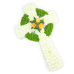 A dignified three-dimensional Celtic cross crafted entirely from fresh flowers, photographed against a bright, clean white background and seen from a gentle overhead angle. The cross's broad arms and elongated shaft are densely packed with pure white spray chrysanthemums, their tiny petals forming a soft, pillowy surface that reads as quiet purity and calm. Woven through that white base are sections of vivid apple-green button chrysanthemums, arranged to define the circular ring where the arms meet and to punctuate alternating panels along the horizontal arms; these lime-green cushions add a tactile contrast and almost a woven, knot-like rhythm to the piece. At the precise centre of the cross sits a small, arresting cluster of three fully opened orange roses - warm, golden-orange petals that glow against the cool white and green and give the tribute a tender, human heart. A few deep green fern sprigs cradle the roses, their feathery texture and darker tone pulling the eye inward and suggesting a natural, respectful frame. Soft studio lighting reveals the delicate sheen of petals and the subtle scent shift from green chrysanthemum freshness to the gentle, honeyed perfume of rose. The composition reads as both contemporary and traditional - a ceremonial memorial suitable for a funeral or remembrance service, particularly for families honouring Irish heritage with its white, green, and orange palette. As a local floral designer familiar with North Watford and nearby Cassiobury Park, I picture this cross placed with care beside a chapel lectern or at a graveside, where its simple geometry and refined colours can speak of memory, faith, and enduring comfort.