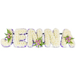 A lovingly composed, three-dimensional tribute spells the name JENNA in bold, uppercase letters formed from hundreds of small, creamy-white chrysanthemums (or similar petite florets), set against a clean white backdrop so every petal reads clearly. Each letter has a soft, cloud-like texture from the dense flowers, while a slender band of deep purple-lilac ribbon or tiny blooms traces the inner edges and base of the lettering, giving crisp definition and a gentle flourish of colour. Delicate clusters of blush-pink and lavender spray roses, mingled with a few pale cream or soft yellow buds and wispy dark-green fern fronds, are artfully placed on the upper curve of the 'J', the lower centre of the second 'N', and the upper right of the 'A', bringing warm contrast and a natural, comforting rhythm across the composition. The letters sit subtly joined by thin, dark support bars that make the piece read as one cohesive, stable memorial display. In soft morning light the whites glow quietly and the roses' scent - faint, sweet and reassuring - seems to lift from the arrangement, offering a gentle presence at a funeral or celebration of life. The overall mood is respectful and intimate: a handcrafted name tribute that reads as both a visual anchor at a service and a tactile expression of remembrance. As a local florist's design from North Watford, it carries the calm, considered style often requested at services near Cassiobury Park and local chapels, a personal and enduring way to honour someone's name with quiet dignity and floral grace.