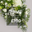 From Flower Delivery North Watford, this Florist Choice Spray is a graceful meditation in white and green against a soft, cool grey backdrop. The heart of the arrangement is anchored by generous hydrangea blooms, their large, cloudlike clusters forming a warm mass toward the top and center. Interspersed among them, classic white roses unfurl in a spectrum of bloom stages-from tightly furled buds to fully opened, satin-smooth petals-creating a living tapestry of texture and light. Delicate lisianthus bells emerge along the edges, some with a pale green tint, adding slender verticals that breathe above the foliage. 

The greens are generous and varied: feathery ferns weave through the lower and right portions, soft grey-green eucalyptus contributes a misty backdrop, and deeper, broader ruscus leaves offer structure and contrast. Small clusters of light green buds hint at new life and freshness, completing the bouquet's sense of renewal. A slim, white rectangular border sits across the central region, bearing Florist Choice in an elegant, flowing script, SPRAY in crisp uppercase, and a bottom line with the price ?100. The text layer carries a gentle glow and semitransparency so the greenery peeks through, reminding us of the living nature of the design. 

For North Watford families and businesses seeking a versatile centerpiece for sympathy tributes, refined gifts, or graceful home styling, this spray conveys dignified warmth. The white-and-green palette remains timeless and adaptable, complementing memorials, anniversaries, or ceremonial occasions with understated elegance. The image implies a premium, ready-to-order product with a promise of careful crafting by a local florist, and it reads as a reliable option on delivery pages across North Watford, available for same-day dispatch to nearby streets as needed.