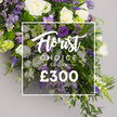 From the heart of North Watford, this long, opulent floral spray is captured lying gracefully on a soft grey background, priced at ?300. The palette is refined-pristine whites and rich purples threaded with fresh greens-a dignified tribute for a funeral. At the heart of the arrangement, ivory white roses sit in generous bloom, complemented by white lisianthus and white freesia that lend softness and lightness. Interleaved among them are deep purple lisianthus, lavender-toned eustoma and freesia, and slim, vertical spires of veronica that rise with composed elegance. Frothy lavender limonium threads between stems, adding delicate texture. The greenery-fern fronds, eucalyptus-inspired leaves, and glossy, sturdy foliage-provides a lush, natural backdrop and adds volume to the arrangement. Light green viburnum-like clusters punctuate the green and white symphony, offering a fresh accent to the design. Centered over the heart of the arrangement is a crisp white overlay, slightly transparent, with the upper line Florist Choice Special in an elegant flowing script, and the lower line SPRAY appears in bold uppercase, followed by the price ?300 in large white numerals beneath. This composition speaks of craftsmanship and care from a neighborhood florist in North Watford, designed to grace services across the district from Watford town centre to leafy residential streets, available for delivery to families and funeral directors with reliability and grace. The light, airy scent of white freesia lingers in the room, a gentle reminder of shared memory and support from the North Watford community.