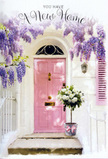 A calm, romantic doorway scene unfolds as if on a peaceful North Watford afternoon, where pastel tones and flowers quietly tell the story of a new home. The front door is a soft, powdery pink, its paint smooth and inviting, set within whitewashed walls that catch the light with gentle, diffused brightness. Above the door, lush wisteria hangs in loose, trailing clusters of lavender and pale purple, creating a canopy of blossom that drapes like a curtain over the entrance, similar to the charming front gardens you might notice near North Watford's residential streets and local schools. At the doorstep, a grey tin bucket sits proudly, filled with a generous bouquet of white and cream roses, their petals unfurling in plump, velvety layers. Sprigs of fresh, soft green foliage weave between the roses, adding texture and a just-picked-from-the-garden feel. A delicate pink ribbon is tied around the bucket, its colour perfectly echoing the door and completing the pastel harmony. The lighting is gentle, with no harsh shadows, suggesting a mild, slightly golden light that makes the colours glow. You can almost sense the sweet fragrance of the roses blending with the heady scent of wisteria, welcoming anyone who steps up to the threshold. It feels like a florist's thoughtful gift for someone settling into a new North Watford address, ready to greet them every time they arrive home, offering comfort, celebration, and the quiet promise that this doorway will soon witness many happy moments.