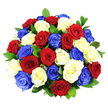 A dramatic, dome-shaped bouquet of roses fills the scene, each bloom open to its fullest and packed so closely that the arrangement appears plush and almost cushion-like. The colour palette is distinctly patriotic, with rich crimson red roses, crisp white roses, and striking cobalt blue roses distributed evenly so that each shade is represented across the surface of the bouquet. The petals have a velvety texture and are arranged in neat layers; some outer petals softly curl away from the centre, giving the flowers a natural, lifelike energy rather than a rigid, formal look. Dark green foliage is tucked between the blossoms, not overpowering but enough to add depth and a fresh, garden-like feel, much like bouquets prepared early in the day by experienced florists serving North Watford. The entire arrangement is photographed against a pure white background, under bright, diffuse lighting that eliminates harsh shadows and makes the reds, whites, and blues appear particularly vivid and saturated. There is no visible vase, stem, or decorative wrapping, so the viewer experiences only the sculpted mass of flowers, as if the bouquet has just been lifted from a workbench close to North Watford station, ready for same-day delivery to a patriotic celebration or remembrance service. The overall effect is bold yet elegant, ideal for marking national holidays, honouring service and sacrifice, or adding a proud, festive focal point to gatherings across North Watford and the surrounding neighbourhoods.