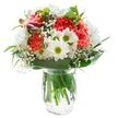 A cheerful, artfully crafted bouquet sits in a sparkling glass vase, exuding freshness and vibrancy in every petal-a signature of North Watford's distinctive floral style. Coral-pink carnations fill the heart of the arrangement, their ruffled petals the embodiment of warmth and energy, recalling the inviting atmosphere of local cafés near St Albans Road. Soft white chrysanthemums cluster nearby, their abundant petals unfolding layer upon layer for a look of gentle refinement, while classic white daisies with bright green-yellow centers nod to sunlight glinting on the Grand Union Canal. Wisps of delicate, snow-white baby's breath are woven skillfully among the larger flowers, adding an ethereal touch that makes the display appear almost cloud-like. Subtly visible on the left, deep magenta buds of alstroemeria linger, hinting at days of future blossom. Framing it all, a generous collar of glossy and slender green leaves anchors the arrangement, echoing the lush parksides and green spaces sprinkled throughout North Watford. The whole composition is arranged in a clear glass vase where you can see fresh stems immersed in water, a testament to its just-picked vitality. Bathed in even light, the bouquet radiates clarity and pure optimism-ready to mark a special birthday, a heartfelt thank you, or simply bring a burst of colour and comfort to any home or workplace across North Watford.